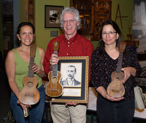 Donelle Sawyer and Nuni Walsh presenting Dick Boak of Martin Guitar with FH Martin's inductee portrait, April 2007