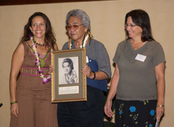 Donelle Sawyer and Nuni Walsh presenting Herb Ohta with his Ukulele Hall of Fame induction portrait, November 2006